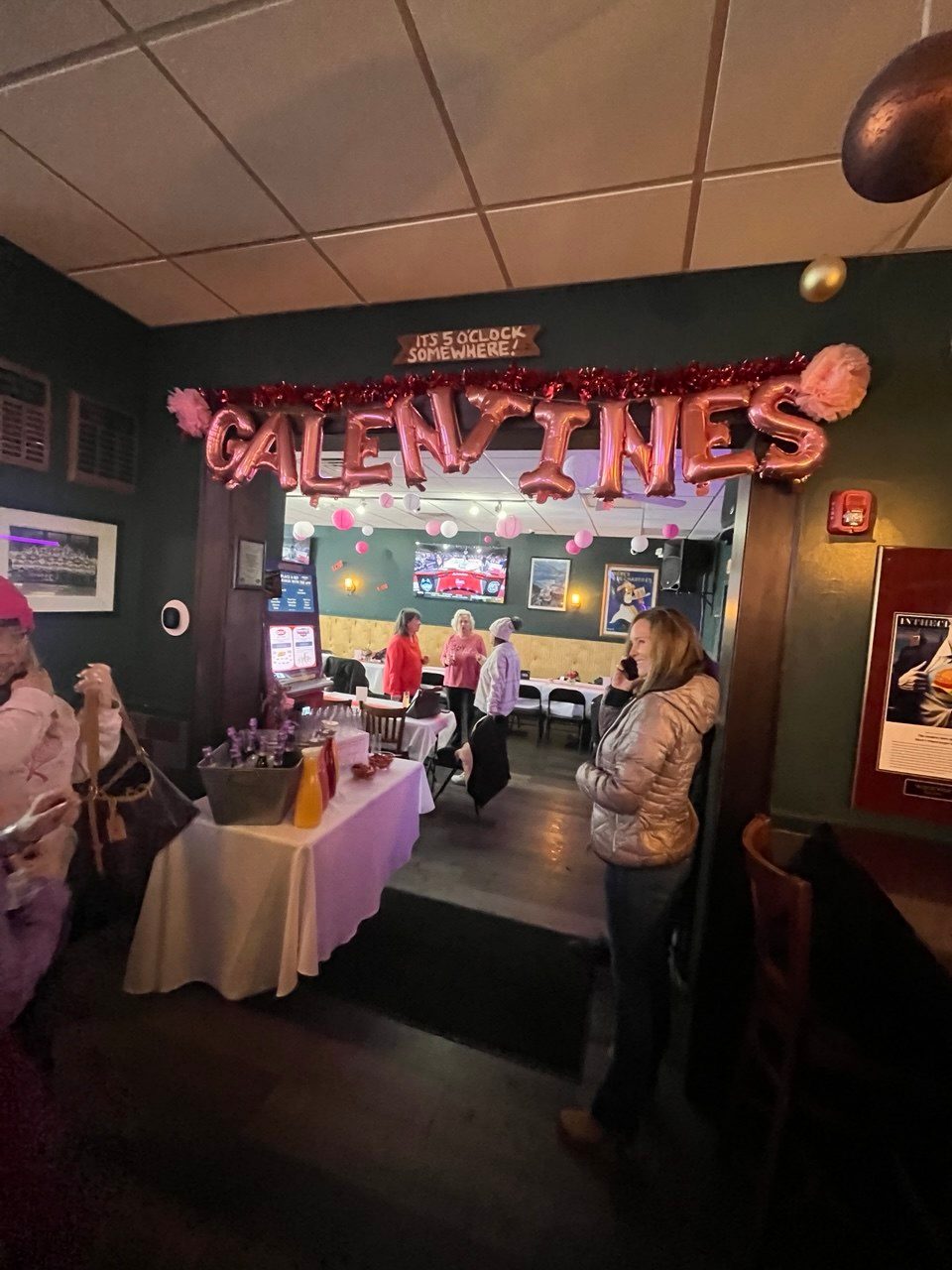 Rose-gold Galentines balloon letters over the back room entrance