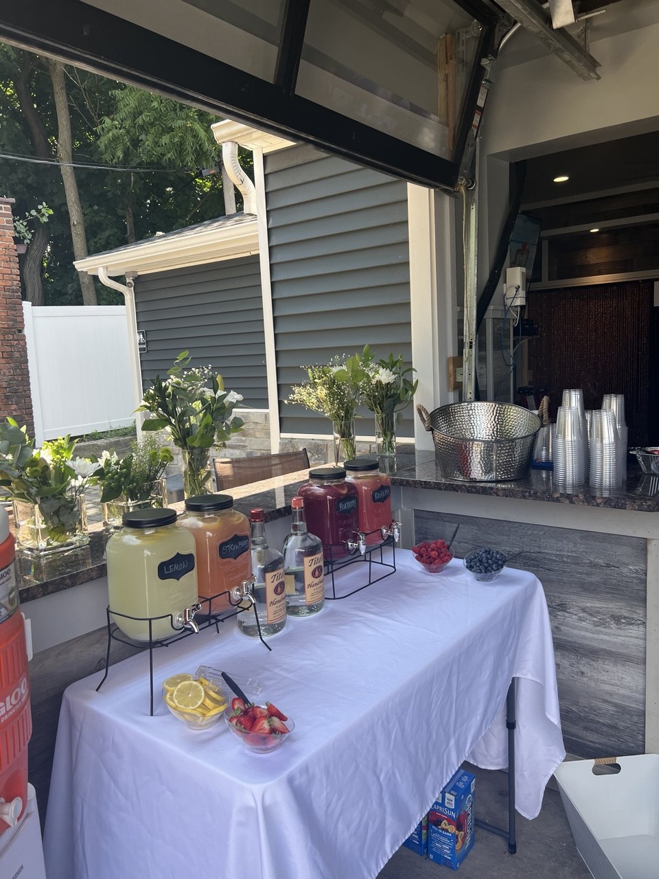 Private event lemonade and vodka bar setup with fresh flowers