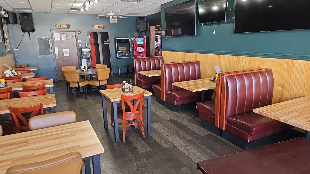 Dining room with red leather booths and butcher-block tables